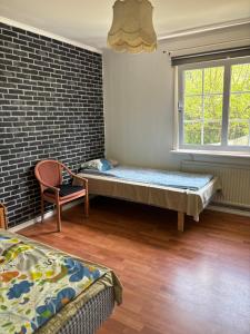 a room with a bed and a brick wall at Vila in Hultsfred