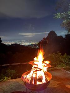 a fire pit with a view of a city at Senda del Cielo in Villa Nueva