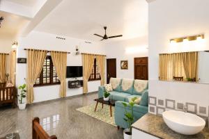 a living room with a couch and a table at Hridyas in Ernakulam