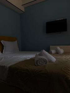 a blue bedroom with a bed with towels on it at G&G დასასვენებელი სახლი in Tsaghveri +5 photos