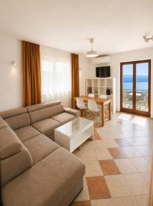 a living room with a couch and a table at Apartments Micic in Lovran +31 photos