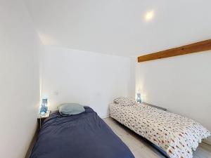 a bedroom with two beds in a room at La Grande Chaumiere in Saint-Vulbas