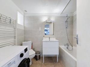 a bathroom with a sink and a toilet and a tub at La Grande Chaumiere in Saint-Vulbas +23 photos