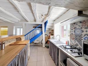 a kitchen with a sink and a stove top oven at La Grande Chaumiere in Saint-Vulbas