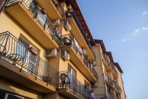a building with balconies on the side of it at Vila Cristal in Baile Felix