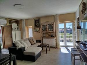 a living room with a couch and a table at Casinha de Lamares in Vila Real