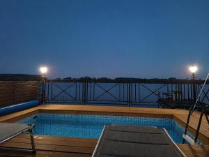 a swimming pool on the balcony of a building at Vila Andreoni,na obali Dunava in Kovin
