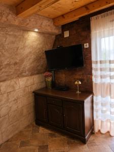 a flat screen tv on a wall in a room at Vila Andreoni,na obali Dunava in Kovin