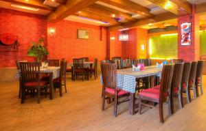 a restaurant with tables and chairs in a room at Treebo Trend Shivam Inn in Lucknow