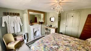 a bedroom with a large bed and a mirror at Market House 17th Century Boutique B&B in Wincanton