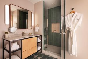 a bathroom with a shower and a sink at Hotel Verdant in Racine +23 photos