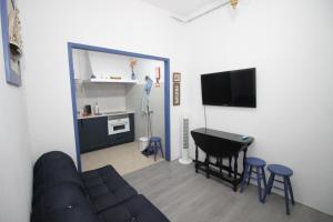 a living room with a couch and a table at Discoveries House Alenquer in Alenquer