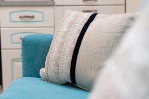 a sock sitting on top of a blue couch at Su Chélu in Villasimius +31 photos