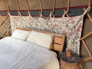 a bedroom with a bed and two pillows at Ash Yurt in Kent