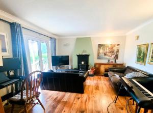 a living room with a couch and a piano at Iona in Blessington