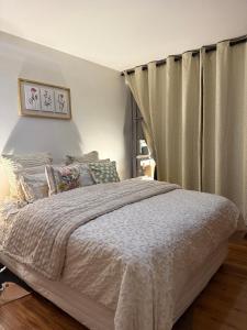 a bedroom with a bed and a curtain at 32 Warnadoone- On Warner beach-Amanzimtoti in Kingsborough