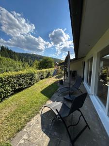 a patio with chairs on a house with a view at Ferienhaus Wiese in Schmallenberg