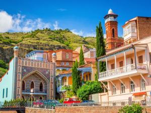 a group of buildings in front of a mountain at ibis Styles Old Tbilisi in Tbilisi City +139 photos