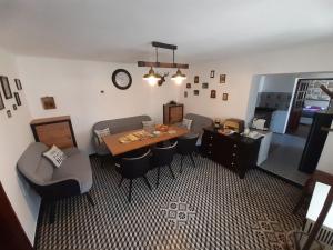 a dining room with a table and chairs and a clock at Patakparti Pihenő in Cserépfalu