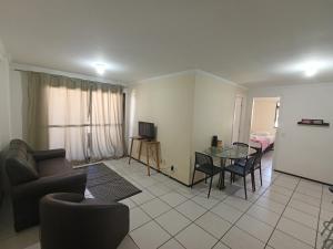 a living room with a couch and a table at Porto de Iracema Vista Mar in Fortaleza