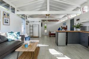 a living room with a couch and a table at Kai Cottage in Bergvliet