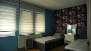 a bedroom with a twin bed and a mirror at Lux Stays in Prishtinë