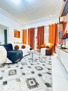 a living room with a couch and a table at Dyden luxury appartement in Douala