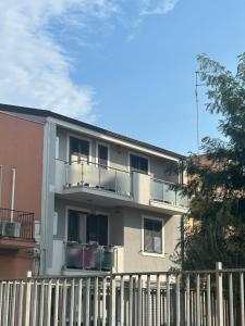 a white building with a fence in front of it at Casa Alessandra in Cassibile