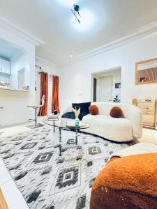 a living room with a couch and a table at Dyden luxury appartement in Douala +14 photos
