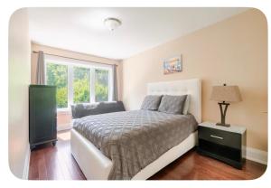 a bedroom with a bed and a window at Unique Home - Upper Toronto Beaches in Toronto