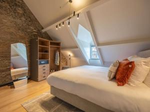 a bedroom with a large bed and a brick wall at Hotel Maison Maastricht Centrum - Handwritten Collection in Maastricht +63 photos