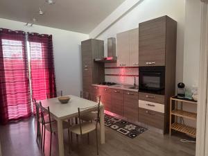 a kitchen with a table and a dining room at Casa Alessandra in Cassibile