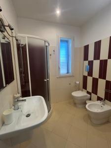 a bathroom with a sink and a shower and a toilet at Casa Alessandra in Cassibile +10 photos