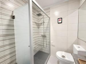 a bathroom with a shower with a glass door at Lovely & Comfy 3 in Estoril