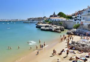 a group of people on a beach in the water at Lovely & Comfy 3 in Estoril