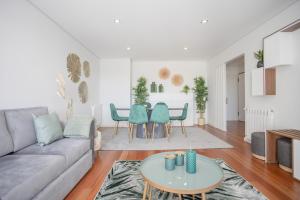 a living room with a couch and a table at Porto & Douro Vista Apartments by Inviting in Valbom