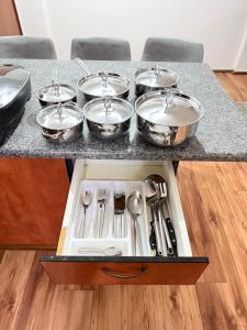 a tray of pots and pans on a kitchen counter at 32 Warnadoone- On Warner beach-Amanzimtoti in Kingsborough