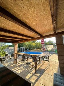 a patio with a ping pong table and chairs at VILLA M Rustic & Spa in Slatina Varoš
