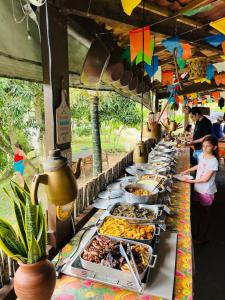 a buffet line with many plates of food at Hotel Fazenda Oásis in Carpina