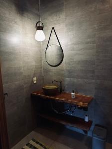 a bathroom with a sink and a mirror at Varanda do Vale in Palmas