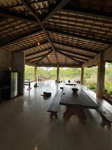 a room with a wooden table in a building at Varanda do Vale in Palmas