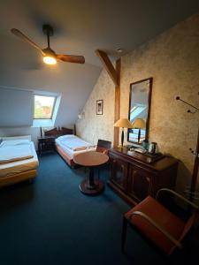 a hotel room with two beds and a mirror at Arkadia Gościniec-klima,parking,ogród in Opole