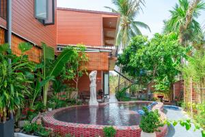 a courtyard with a fountain in front of a building at Mai House Homestay - Long-term rental in Hoi An, Da Nang in Thanh Ðông (1)
