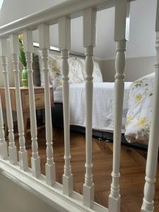 a staircase with white railings in a bedroom at The River Nook in Termonbarry