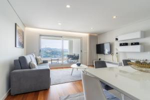 a living room with a couch and a table at Porto & Douro Vista Apartments by Inviting in Valbom
