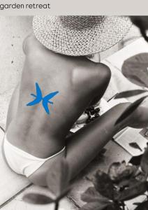 a woman in a hat with a star tattoo on her leg at Rada room&suite in Favignana
