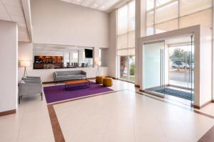 a living room with a couch and a table at City Express by Marriott Saltillo Sur in Saltillo