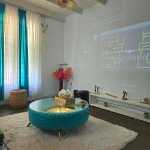 a living room with a round table with books on it at Palm Paradise in Diani Beach
