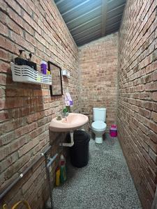 a brick bathroom with a sink and a toilet at Rumah Singgah in Bentong +9 photos