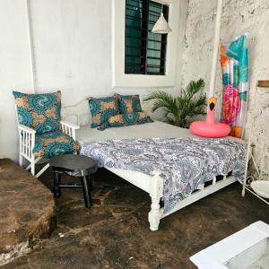 a bed and a chair in a room at Palm Paradise in Diani Beach